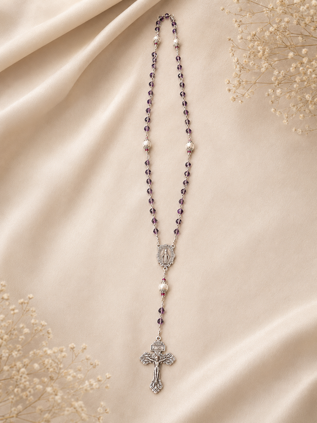 Purple Devotion Rosary with purple beads, silver centerpiece, pearl accent beads, and crucifix